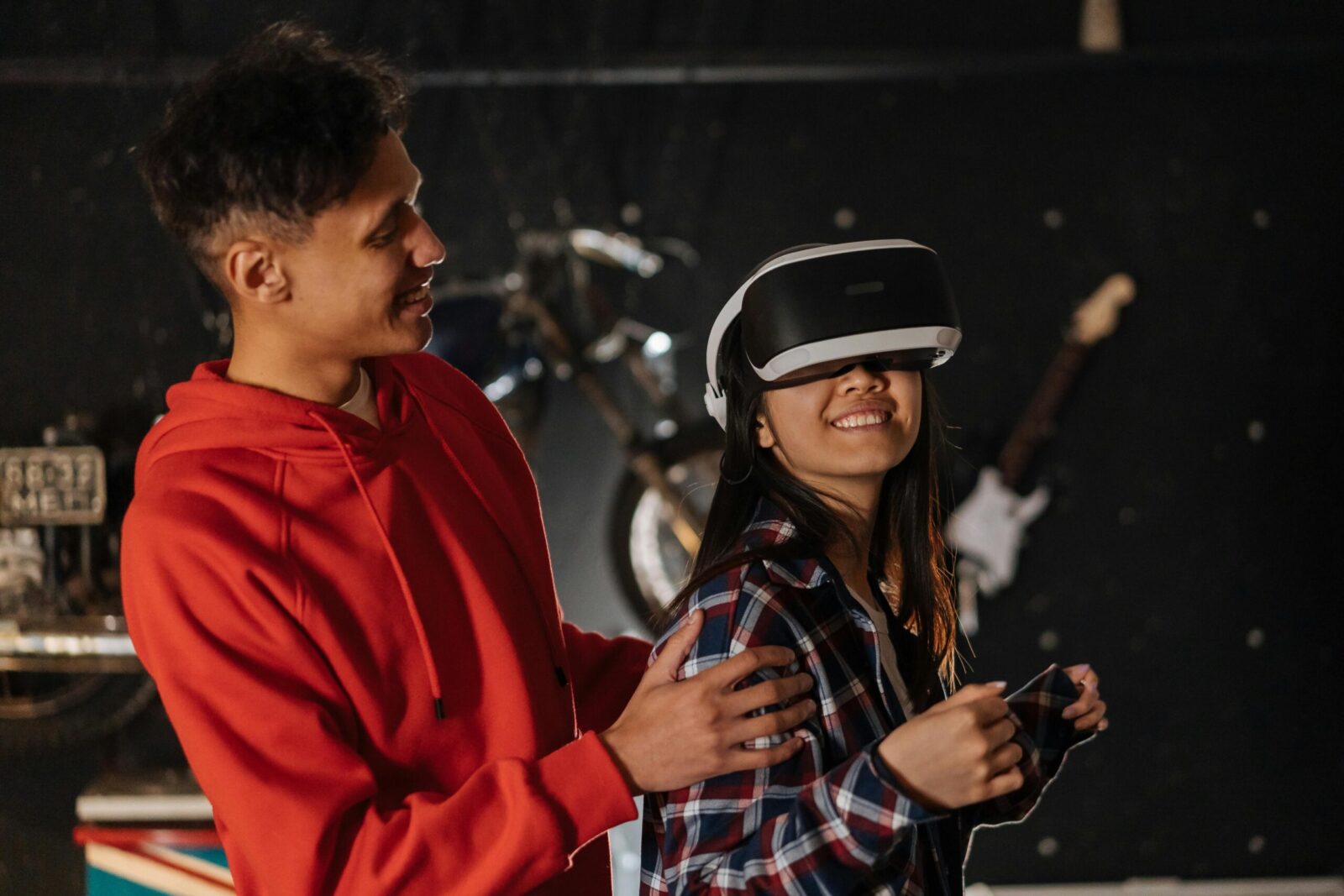 Two young adults having fun with virtual reality goggles, enjoying a leisure activity indoors, adding a modern twist to social interaction.